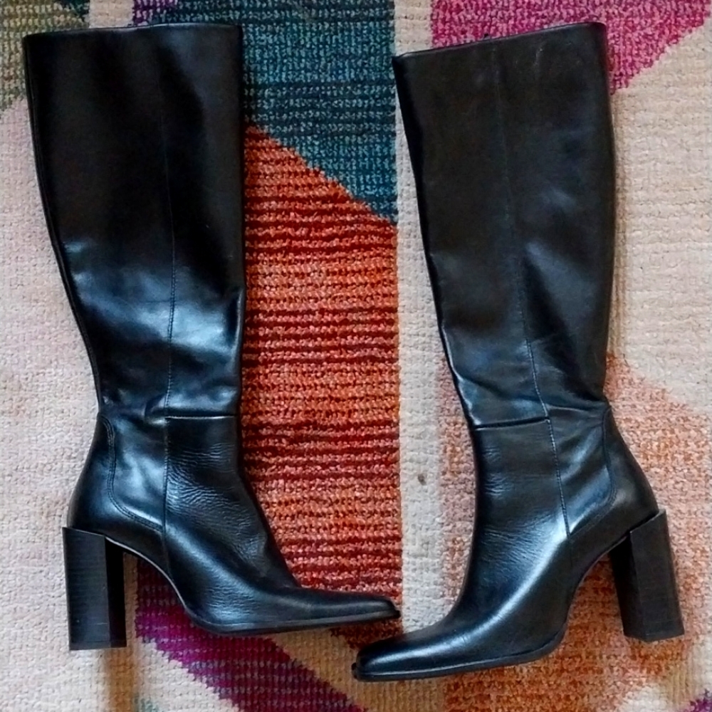 Knee-high, high-heeled black leather boots